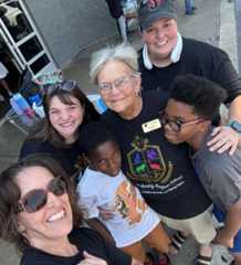 Volunteers from Jonesboro Leadership Magnet School visit with some of their students at Stuff the Bus