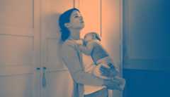 Postpartum depression Photo, with shading, of a young woman holding an infant in her arms. She is leaning against the wall with a despairing look in her eyes.