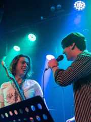 College students performing music on a stage.