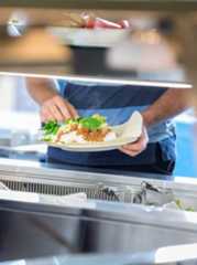 A college student with a plate of nutritious food.