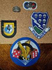 Some patches from the 101th Airborne Division, and patches from the 506th PIR, next to the jumpwing is a Sterling silver ring with 506 and a parachute. (Private Collection).