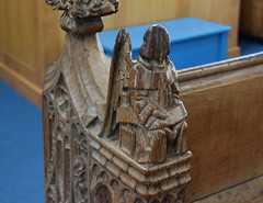 seated angel holding a scroll