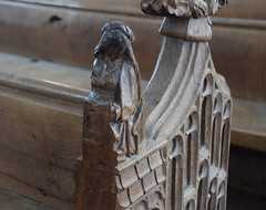 Blessed Virgin at the Annunciation seated at a prayer desk holding lilies
