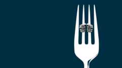 Hands holding onto the tines of a fork like prison bars.