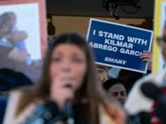 Supporters hold up signs as Jennifer Vasquez Sura the wife of Kilmar Abrego Garcia who was mistakenly deported to El...