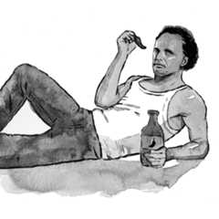Walton Goggins lying down and posing with a jalapeño and a bottle of jalapeño tequila.