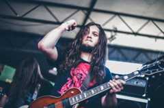 Image may contain Musical Instrument Guitar Leisure Activities Human Person and Bass Guitar