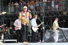 Image may contain Human Person Musical Instrument Guitar Leisure Activities Musician Mike Love Stage and Music Band