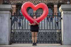 A protester stands at the gates of the Massachusetts State House. (Robin Lubbock/WBUR)