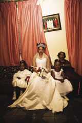 A bride before her wedding sitting with her bridesmaids.