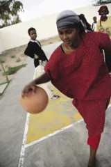 A young woman plays basketball at Socsa (Somaliland Culture and Sports Association)