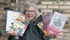 UC Berkeley librarian Ann Glusker holds up books about collecting oral histories