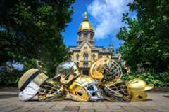 Several examples of gold helmets worn by various Notre Dame intercollegiate athletics teams, from left to right: Fencing, Men’s Lacrosse, Baseball, Football, Hockey, Men’s Lacrosse and Softball (Photo by Matt Cashore/University of Notre Dame)