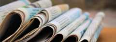 Stack of newspapers on wooden table