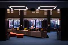 Students study on the newly renovated first floor of Bobst Library. The renovations include new couches, blue carpeting and updated lighting fixtures.