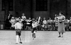 A young Prince Charles runs between the wickets at Hill House School