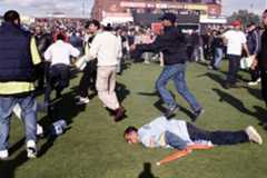 An India fan falls to the ground during a pitch invasion at Old Trafford during the 1999 World Cup game between the two sides