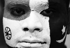 A fan gets his face painted in the India and Pakistan colours