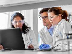 clinical scientists with laptop working in laboratory