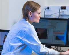 White woman scientist working on computer