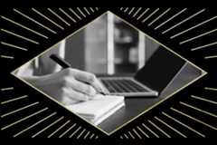 Black and white image of a hand writing in a notebook, possibly noting ideas for literary grants, next to an open laptop on a desk. The photo is framed by a diamond-shaped design with radiating lines.