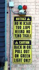 A caution sign with instruction written in mirror writing and in regular writing