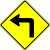 [road sign: a black arrow that goes up and then to the left; background is a yellow diamond]