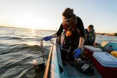 Graduate students studying water resources engineering and science, collect data and water samples from Lake Mendota near the University of Wisconsin-Madison campus