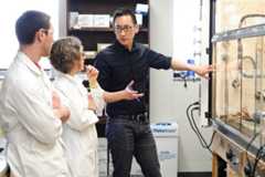 Tehshik Yoon (right), associate professor of chemistry, holds a discussion with graduate research assistant Travis Blum (left) and research associate Dani Schultz in a lab at UW-Madison