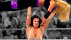 Victoria (Lisa Marie Varon) military presses Trish Stratus. The pair had some hard-hitting affairs and always gave their all when they met in the ring.