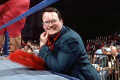 Him Cornette smiling as he stands at the side of the ring