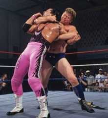 Bob Backlund with his arm around Bret's neck and his left arm locked during a match