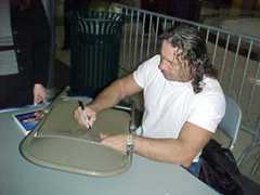 Bret Hart autographing a metal chair