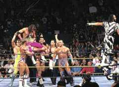 Bret Hart lifted up on the shoulders of other wrestlers in the ring