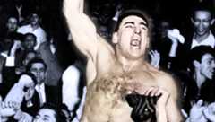 Antonino Rocca rides on the shoulders of fans after police break up the riot around the ring at Madison Square Garden on November 19, 1957.