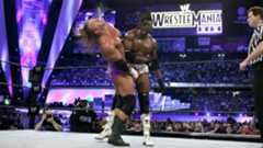 Booker T trades strikes with Triple H in their WrestleMania XIX World Heavyweight Title clash that ended in a disputed Pedigree pin. 