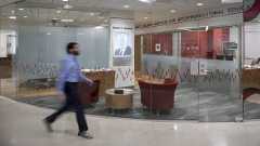 A person walking in front of the Baldwin Institute.