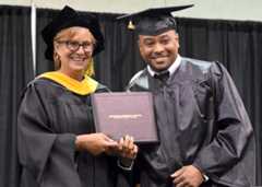 May 2023 RCC graduate smiles from stage.