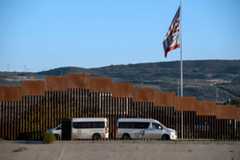 Mexican migration authorities guard one of the sides of the Tijuana River at the U.S.-Mexico border seen from Tijuana, Baja California state, Mexico. 