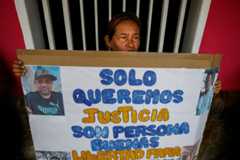 A woman holds a sign against the deportation of 238 Venezuelans from the U.S. to a Salvadoran jail, in Maracaibo, Venezuela on March 18. 