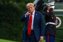President Donald Trump walks on the South Lawn of the White House on Sunday evening. 