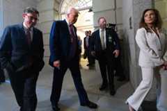 President Donald Trump, flanked by Speaker Mike Johnson and House GOP Conference Chair Lisa McClain, is pictured at the Capitol on May 20.