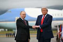 President Donald Trump shakes hands with Russian President Vladimir Putin on the tarmac after they arrived at Joint Base Elmendorf-Richardson in Anchorage, Alaska, on Friday.