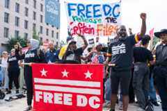 Protesters on Monday in downtown Washington, D.C., object to President Trump's move to exert more federal control over the city.