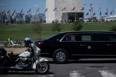 President Donald Trump rides in his motorcade Monday as he passes the Washington Monument on the National Mall in Washington, D.C. 