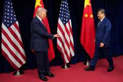 President Donald Trump greets Chinese President Xi Jinping on Thursday ahead of a summit meeting at Gimhae Air Base in Busan, South Korea. (Andrew Harnik/Getty Images)
