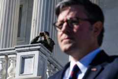 Police watch over the East Front of the Capitol as Speaker Mike Johnson attends a news conference on Nov. 5. While many members say they feel protected at the heavily fortified Capitol, security while traveling in their districts can be another story.
