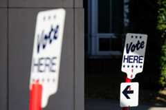 Signs are seen outside a high school gymnasium in Alexandria, Va., on Election Day 2024.