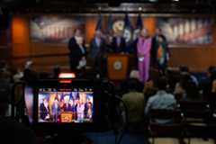 House and Senate Democrats, pictured in a TV monitor, hold a joint news conference on Department of Homeland Security funding negotiations on Capitol Hill on Feb. 4.
