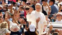 Pope Leo XIV waving to a crowd of people